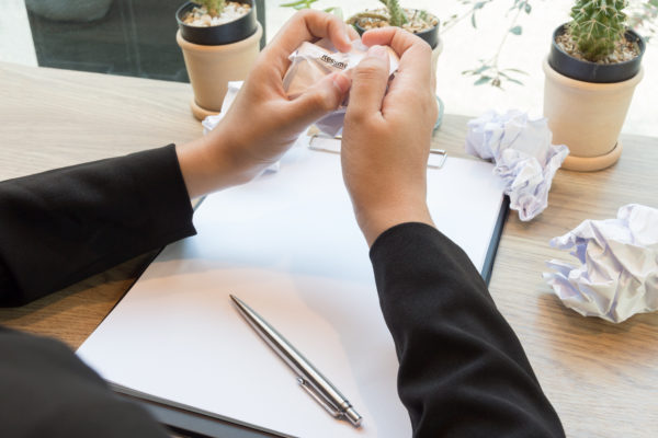 Hand crumple sheets of Resume at the desk