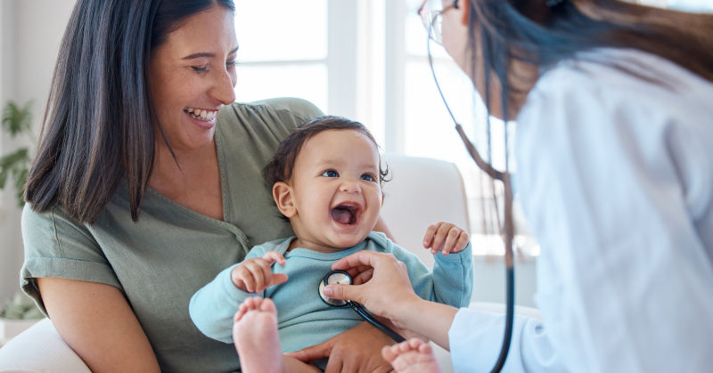 Mother, baby and stethoscope of pediatrician for healthcare consulting, check lungs and breathing for heartbeat. Doctor, happy infant kid and chest assessment in clinic, hospital and medical analysis Female medical provider listening intently and with compassion to a patient.
