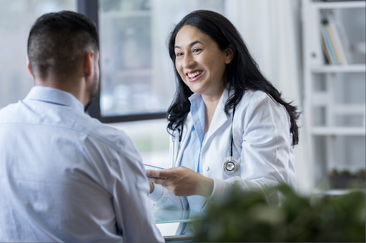 Female physician speaking to a patient with a smile.